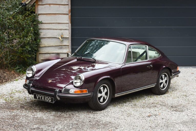 Porsche 911 parked up outside a garage