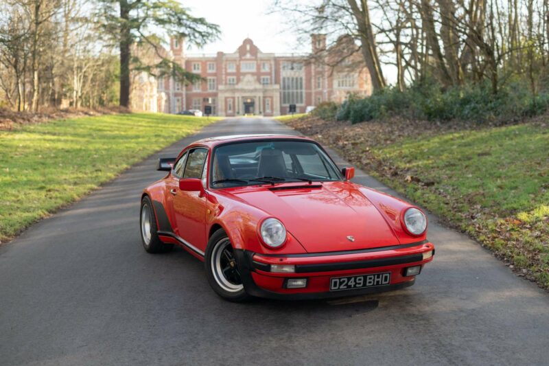 Red Porsche 911 parked up on road