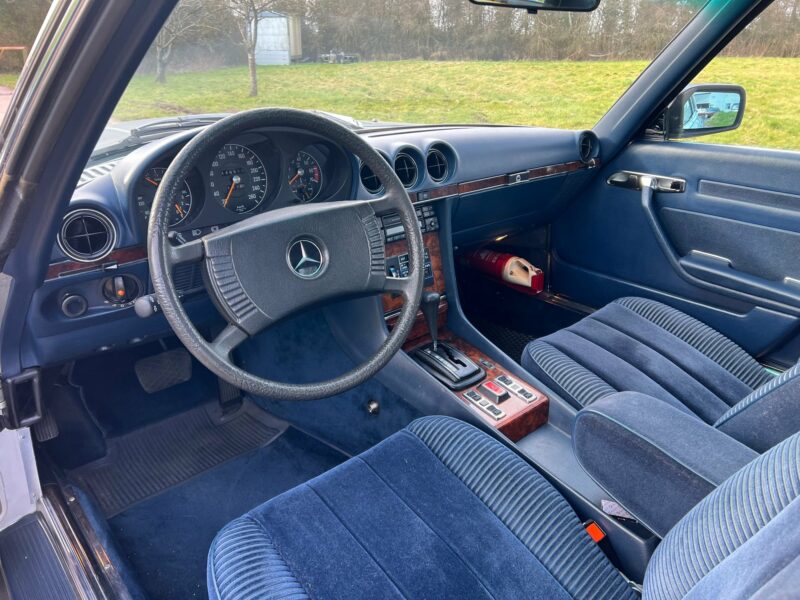 Blue velour interior of Silver metallic Mercedes C107 450SLC 5L